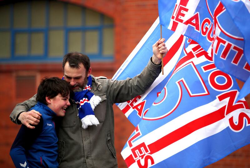 Fans celebrate outside the Ibrox Stadium after Rangers won the Scottish Premiership title.