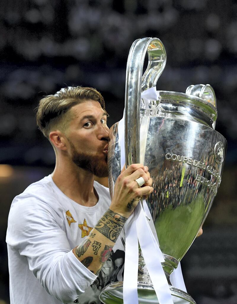 MILAN, ITALY - MAY 28:  Sergio Ramos of Real Madrid kisses the trophy after winning the UEFA Champions League Final match between Real Madrid and Club Atletico de Madrid at Stadio Giuseppe Meazza on May 28, 2016 in Milan, Italy.  (Photo by Matthias Hangst/Getty Images)