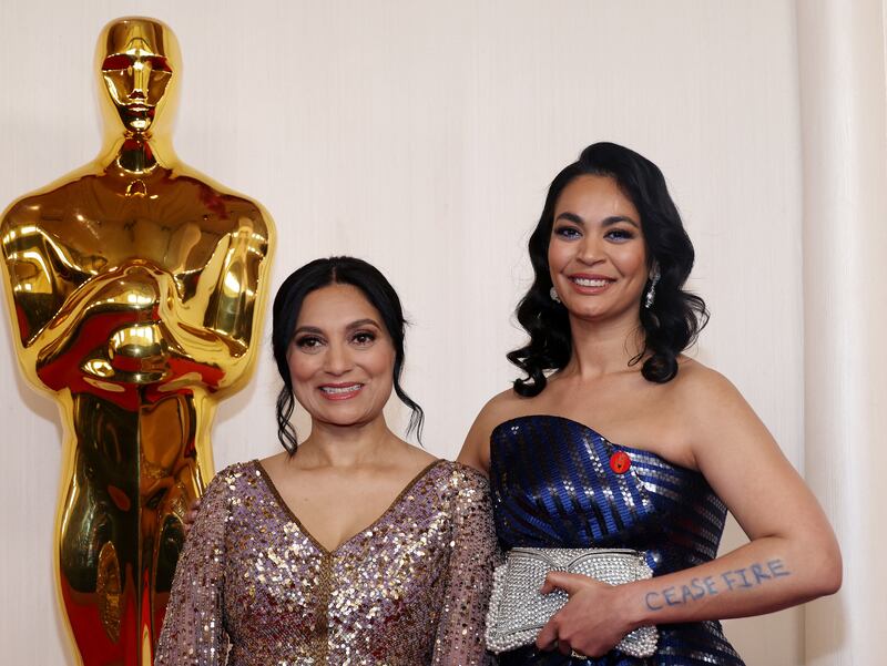 Filmmaker Shruti Ganguly, right, and a guest pose on the red carpet during the 96th Academy Awards. Reuters 