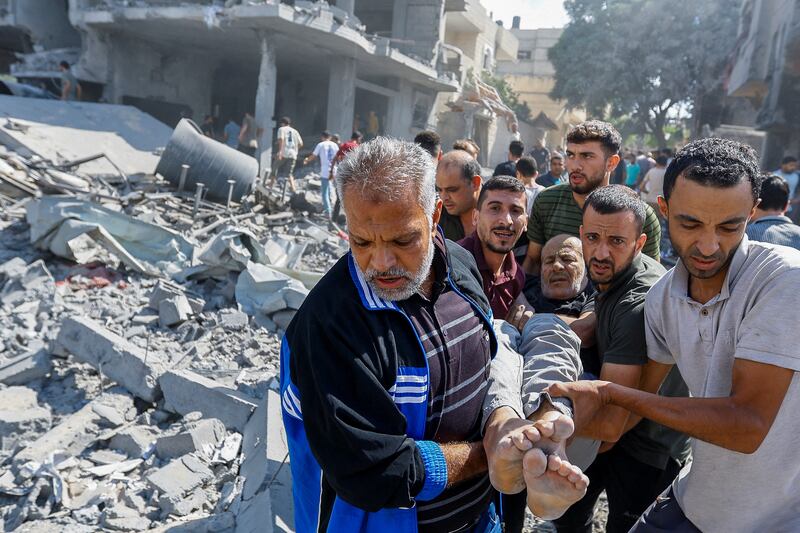 Palestinians carry a wounded man following Israeli strikes in Rafah, southern Gaza Strip. Reuters