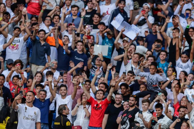 Eden Hazard takes photos with supporters inside the Bernabeu stadium. AP Photo