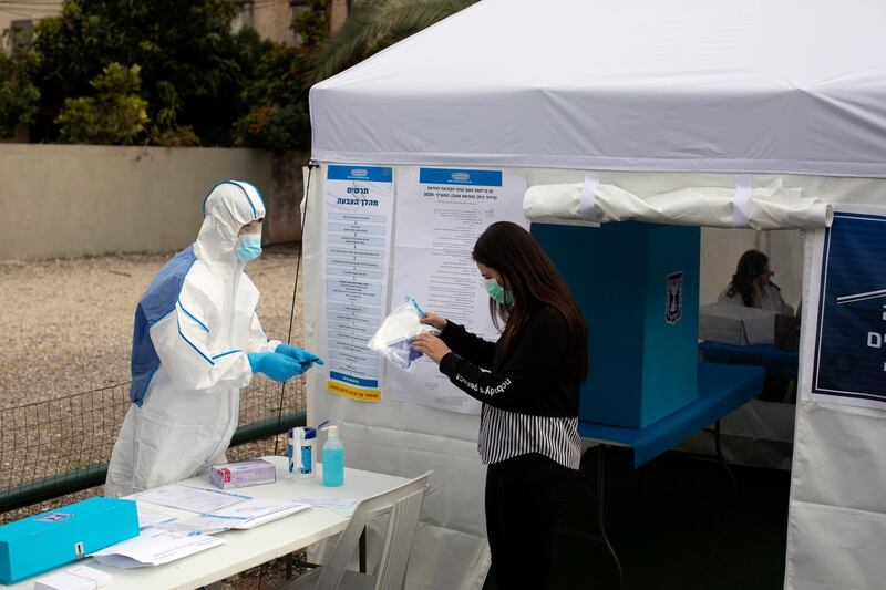 Staff from Israel's Central Election Commission prepare a special polling station for quarantined Israelis.  AFP