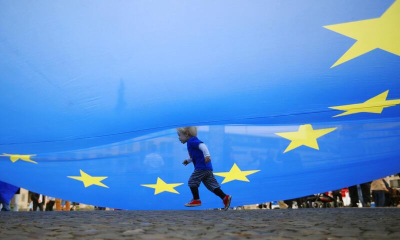A child runs under an EU flag during a rally under the slogan "Stop the Coup" to protest against attempts to force through a no-deal Brexit, in Berlin, Germany.  Reuters