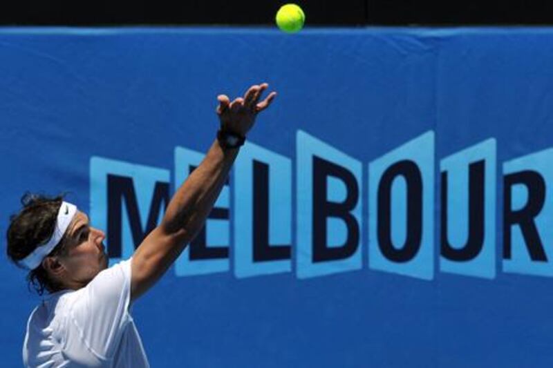 Rafael Nadal of Spain serves during a training session ahead of the 2012 Australian Open tennis tournament in Melbourne on January 15, 2012.  The tennis season's first Grand Slam of the year will take place from January 16 to 29.   IMAGE STRICTLY RESTRICTED TO EDITORIAL USE - STRICTLY NO COMMERCIAL USE      AFP PHOTO / PAUL CROCK

