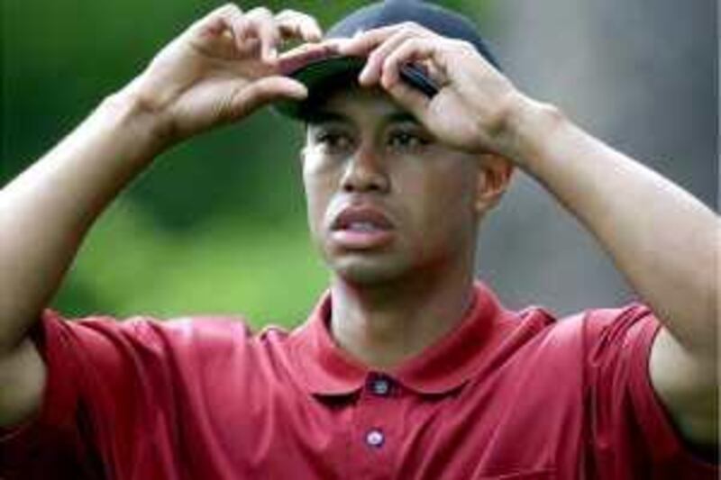 Tiger Woods adjusts his cap on the seventh tee during the final round of the 2001 Masters at the Augusta National Golf Club in Augusta, Ga., Sunday, April 8, 2001. (AP Photo/Dave Martin)