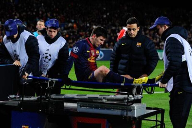 Barcelona's Lionel Messi is stretchered off against Benfica.