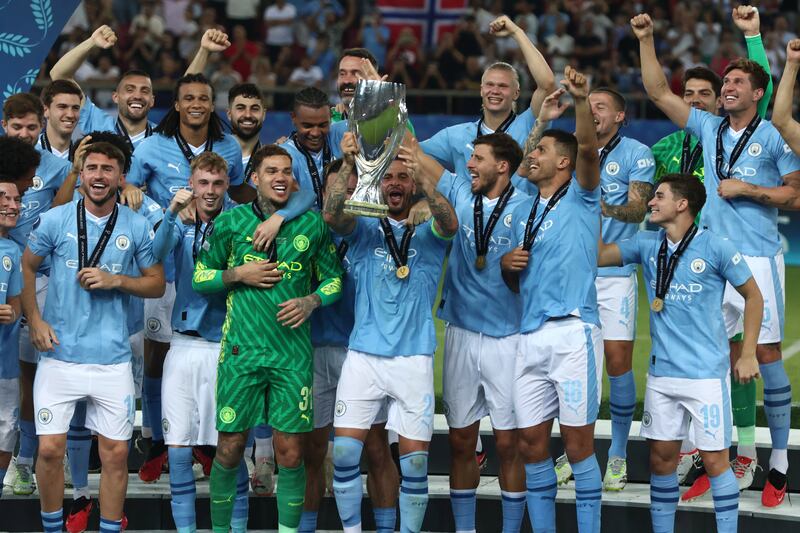 Manchester City players celebrate with the trophy after defeating Sevilla to win the UEFA Super Cup at the Karaiskakis Stadium in Piraeus, Greece, on Wednesday, August 16, 2023. EPA