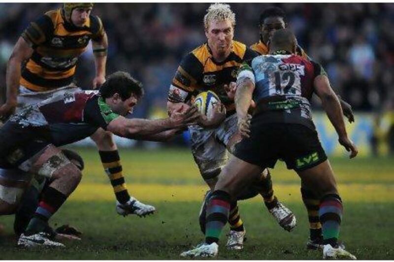 Andy Powell, centre, the Wasps forward, takes on the Harlequins defence during an Aviva Premiership match earlier this month.