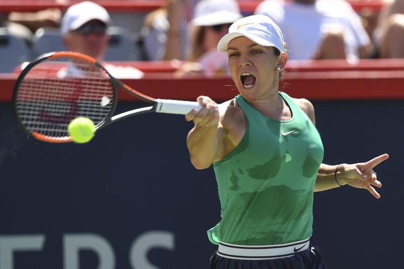 MONTREAL, QC - AUGUST 11: Simona Halep of Romania hits a return against Ashleigh Barty of Australia during day six of the Rogers Cup at IGA Stadium on August 11, 2018 in Montreal, Quebec, Canada.   Minas Panagiotakis/Getty Images/AFP
== FOR NEWSPAPERS, INTERNET, TELCOS & TELEVISION USE ONLY ==
