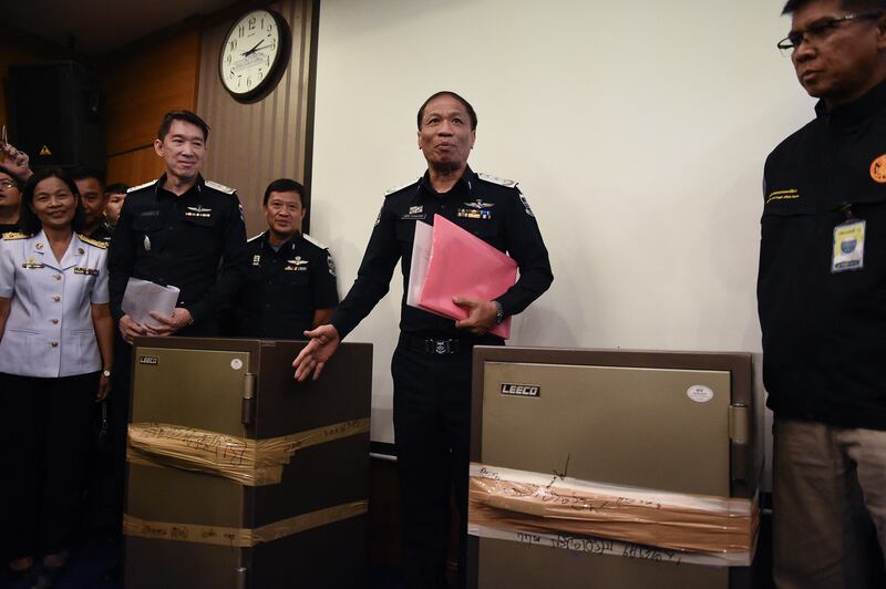 Thai police with safes seized during a raid on a 'Victoria Secret' massage parlour in Bangkok. The operation was carried out owing to suspicions of trafficking and prostitution. AFP