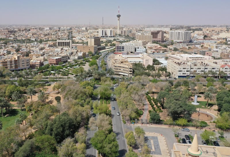 An aerial picture shows cars driving on a tree-lined road in the Saudi capital Riyadh, on March 29, 2021. - Although the OPEC kingpin seems an unlikely champion of clean energy, the "Saudi Green Initiative" aims to reduce emissions by generating half of its energy from renewables by 2030. (Photo by - / AFP)