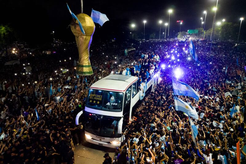 Argentina's players inch through Buenos Aires with the World Cup trophy in front of throngs of adoring fans. AFP