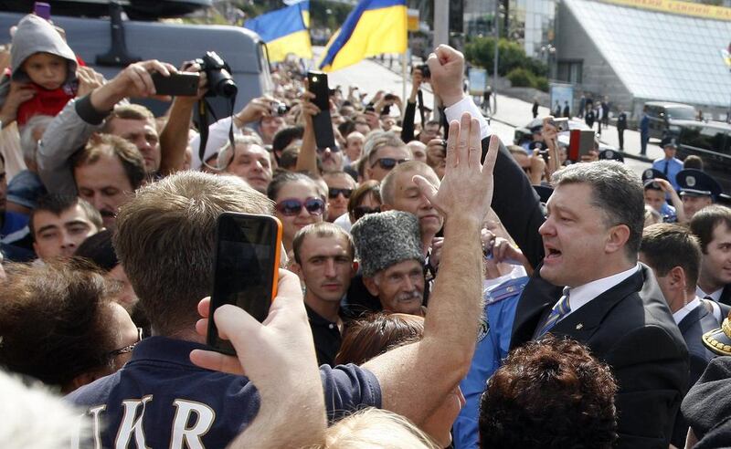 Ukrainian president Petro Poroshenko raises his fist in front of the audience during the military parade. President Petro Poroshenko declared on Sunday that Ukraine’s war against pro-Russian separatists would likely enter history as ‘the 2014 patriotic war’. Yuriy Kirnichny/AFP Photo