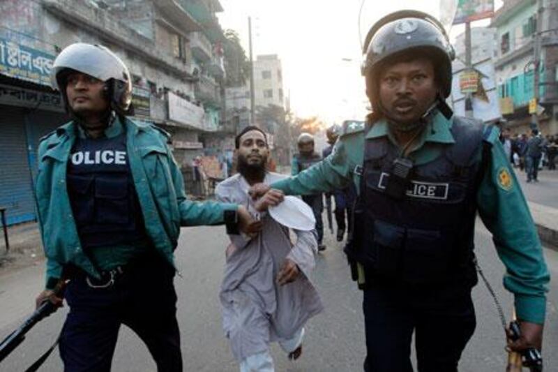 Police arrest a member of Jamaat-e-Islami on suspicion of vandalising a car during a day-long strike in protest against the life sentence given to Abdul Quader Mollah on Tuesday. Andrew Biraj / Reuters