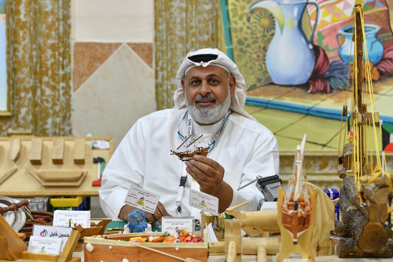 An exhibitor shows a model of a traditional boat at the summer festival of heritage and handicraft in Kuwait City, Kuwait. EPA