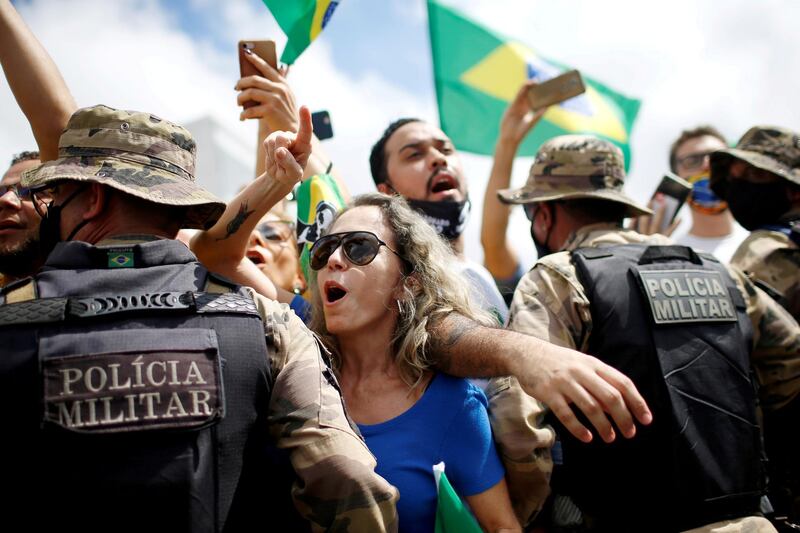 Demonstrators take part in a protest in favour of Brazilian President Jair Bolsonaro in front of the Planalto Palace, amid the coronavirus outbreak, in Brasilia, Brazil. Reuters
