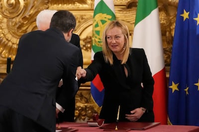 Newly appointed Italian Premier Giorgia Meloni shakes hand with deputy prime minister Matteo Salvini during the swearing-in ceremony. AP