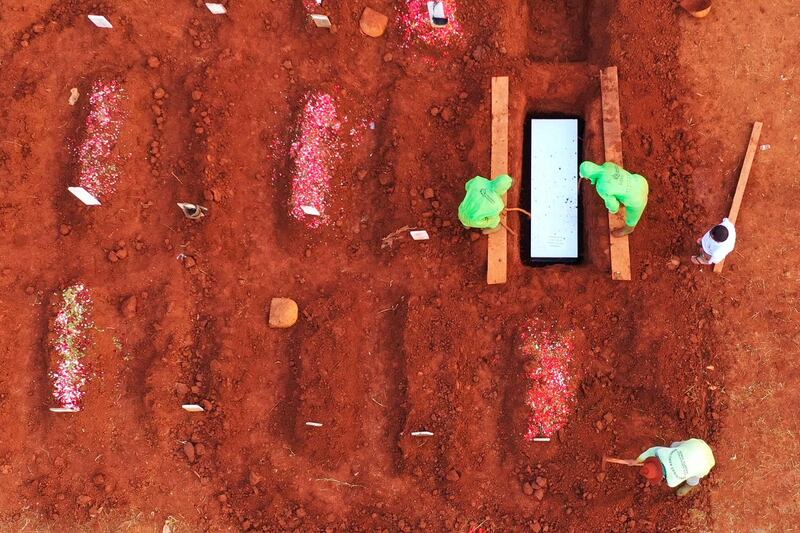 Gravediggers bury victims of the coronavirus at the Pondok Ranggon cemetery in Jakarta.  AFP