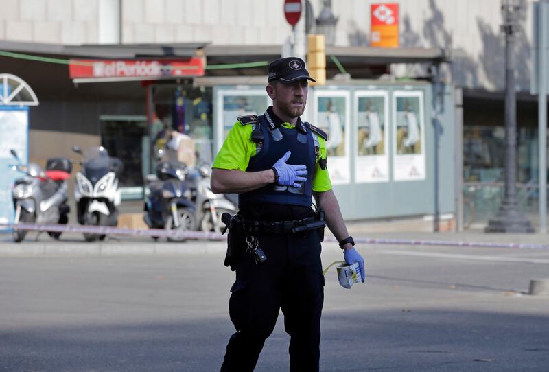 A police officer cordons off a street in Barcelona, Spain. Manu Fernandez / AP Photo.