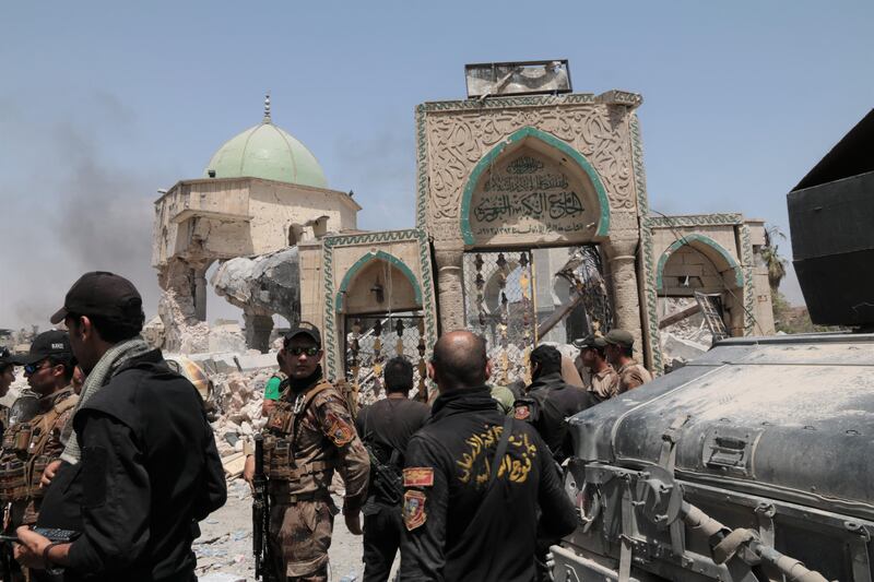 Iraqi special forces mill around the entrance of the destroyed Al Nuri Mosque. Florian Neuhof  / The National