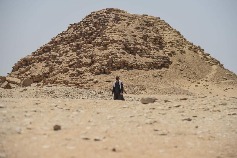 A man walks in front of one the Bent pyramid satellites, in the ancient royal necropolis of Dahshur. AFP