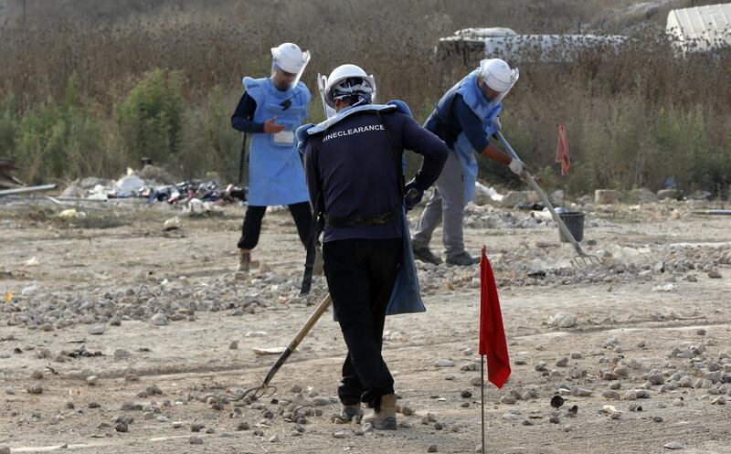 Deminers from the HALO Trust work during an operation to remove and clean mines on the outskirts of Tulkarem, the West Bank.  EPA