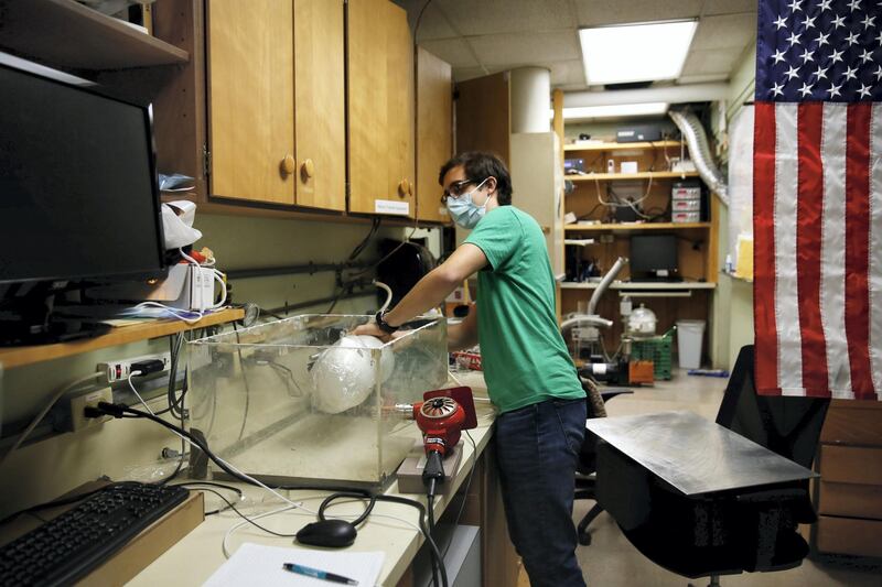 LOS ANGELES, CA - MAY 27: Albert Nazeeri demonstrates his experiment to disinfect respirator masks inside his lab at the California Institute of Technology in Pasadena on Wednesday, May 27, 2020 in Los Angeles, CA. Nazeeri, a Caltech student, was asked to watch over the geobiology laboratory once the coronavirus shutdown hit and he wound up studying the disinfecting technique with the time. (Dania Maxwell / Los Angeles Times via Getty Images)