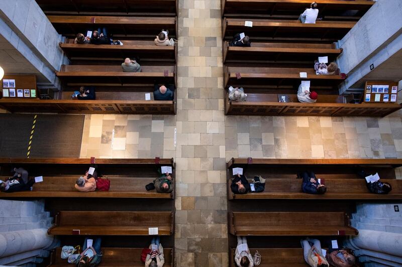 Faithful attend the first service at the Great Minster church in Zurich, Switzerland. AP