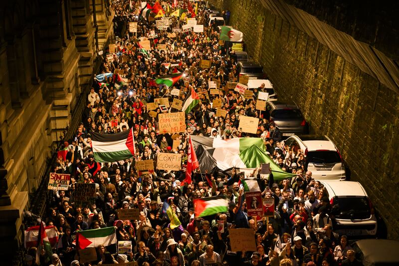 Protesters hold placards and Palestinian flags during a rally in support of Palestinians, in Lausanne, Switzerland. EPA