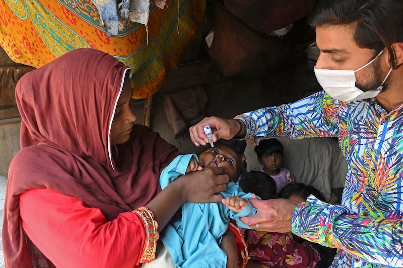 A health worker administers polio vaccine drops in Lahore. AFP