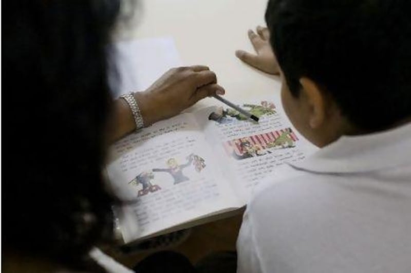 A student receives instruction in an Abu Dhabi school. The average teacher turnover rate among schools in the Middle East is 20 per cent.