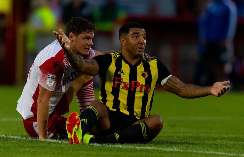 STEVENAGE, ENGLAND - JULY 27:   Troy Deeney of Watford FC and Luther Wildin of Stevenage react during the pre-season friendly between Stevenage and Watford at The Lamex Stadium on July 27, 2018 in Stevenage, England. (Photo by Paul Harding/Getty Images)