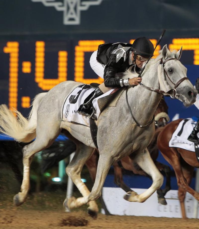 Jockey Royston Ffrench guides AF Lafeh from the outside to win the Mazrat Al Ruwayah, a Group 2 race purebred Arabians, at Meydan Racecourse in Dubai on Thursday night.  Jeffrey E Biteng / The National 
