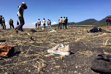 People walk at the scene of the Ethiopian Airlines Flight ET 302 plane crash. Reuters