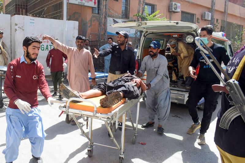 Volunteers carry a blast victim on a stretcher at a hospital in Quetta after a suicide bombing in Mastung district. AFP