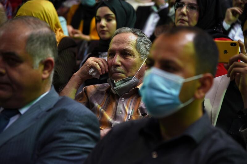 Iraqis attend a concert by the Watar orchestral ensemble at the Rabea Theatre in Mosul on April 8, 2021. EPA