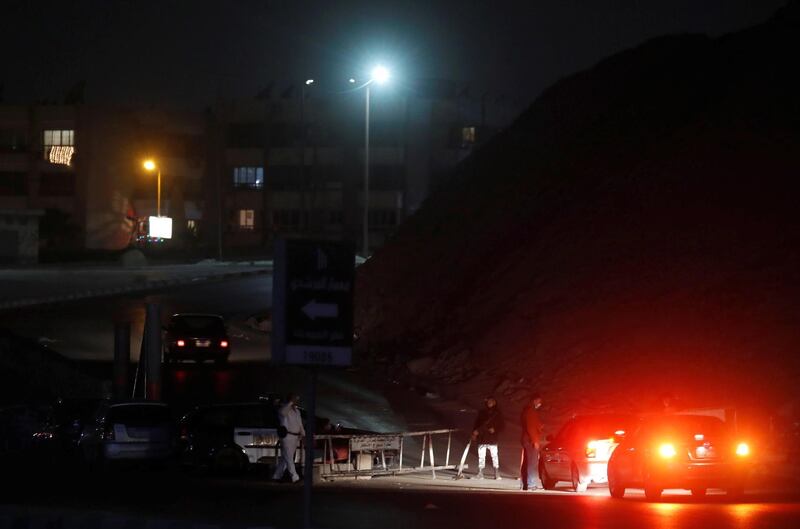A police checkpoint at the area of the Cairo suburb of Maadi during a night-time curfew to contain the spread of the coronavirus. Reuters