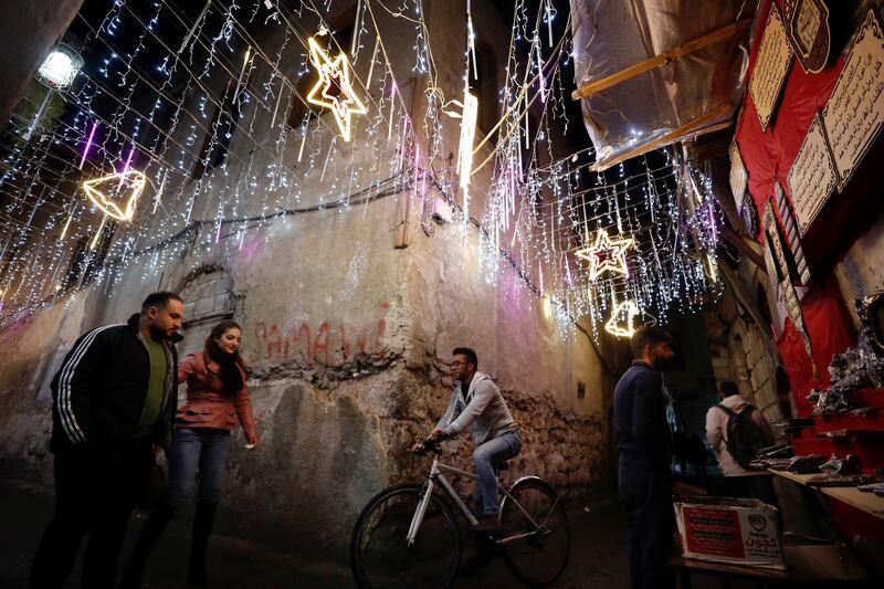 People walk in the Old City of Damascus, which is decorated for the approaching Christmas holidays. AP