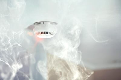 Smoke detector mounted on roof in apartment