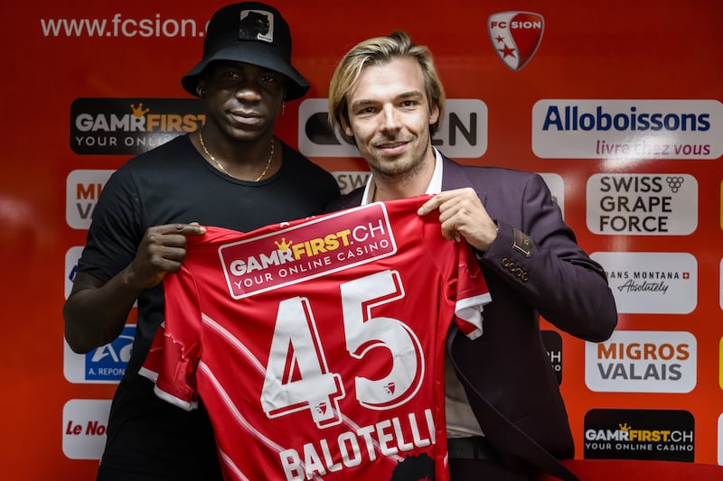 Mario Balotelli of Italy and new FC Sion soccer player, left, poses with Barthelemy Constantin, right, sport director of FC Sion, during a press conference at the Stade de Tourbillon stadium, in Sion, Switzerland, 01 September 2022.   EPA / JEAN-CHRISTOPHE BOTT