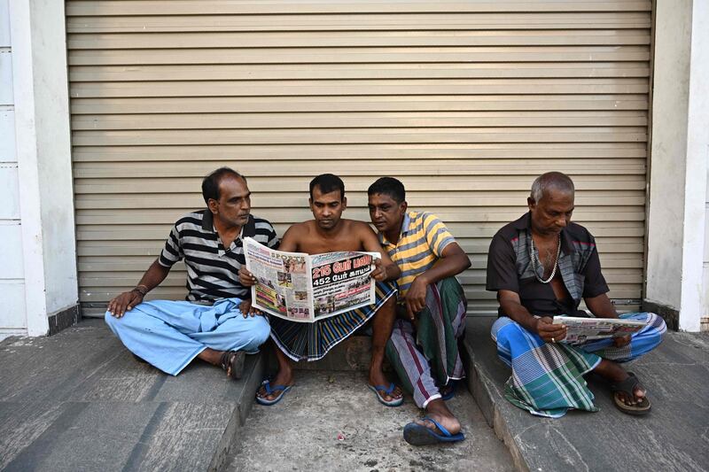 Residents read newspapers near St. Anthony's Shrine in Colombo a day after a series of bomb blasts targeting churches and luxury hotels in Sri Lanka. At least 290 are now known to have died in a series of bomb blasts that tore through churches and luxury hotels in Sri Lanka, in the worst violence to hit the island since its devastating civil war ended a decade ago. AFP