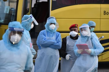 Healthcare workers in Malaysia wear protective suits as they prepare to check passengers for coronavirus at Kuala Lumpur International Airport. AFP