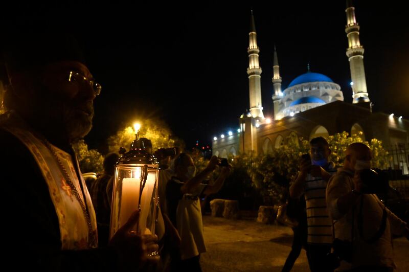 A Greek Orthodox Christian priest carrying the Holy Fire makes his way through a crowd of believers as he arrives at Beirut's Saint George Greek Orthodox Cathedral from Jerusalem via Amman. EPA