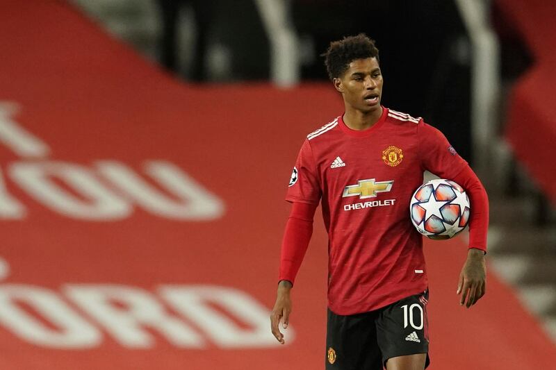 Manchester United's Marcus Rashford walks off with the match ball. AP