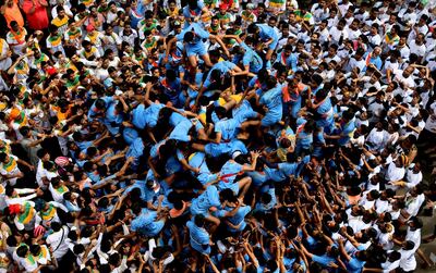Young men form a human pyramid and attempt to reach the Dahi Handi during celebrations in Mumbai. AP