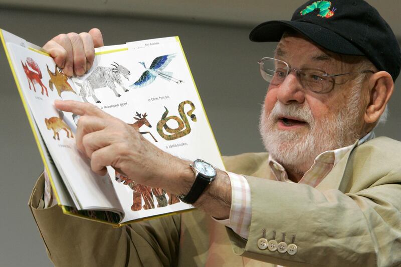 FILE - Illustrator Eric Carle reads from "Baby Bear, Baby Bear, What Do You See?" on Oct. 1, 2007 in New York. The beloved childrenâ€™s author and illustrator whose classic works gave millions of kids some of their earliest and most cherished literary memories, has died. Carle was 91. Through books like â€œBrown Bear, Brown Bear, What Do You See?â€ â€œDo You Want to Be My Friend?â€ and â€œFrom Head to Toe,â€ Carle introduced universal themes in simple words and bright colors. (AP Photo/Mary Altaffer, File)