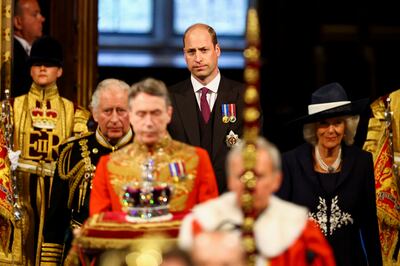 Britain's Prince Charles, Camilla, Duchess of Cornwall, and Prince William proceed behind the Imperial State Crown through the Royal Gallery for the State Opening of Parliament. Reuters