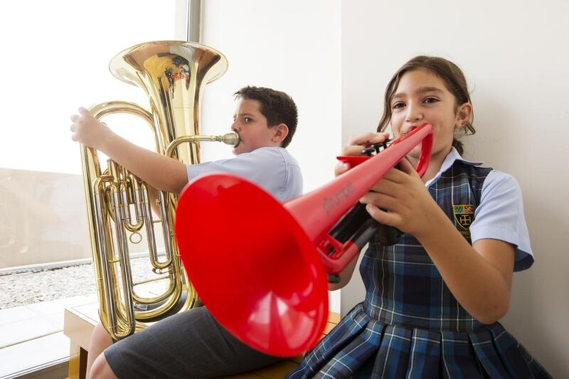 Hugo John, 11, and Alexandra Mitsis, 9, members of the Cranleigh School wind band, toot their horns. The Saadiyat Island school promotes extra-curricular activities such as sports, music and the arts to mould more confident and well-rounded pupils. Christopher Pike / The National