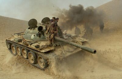 Defecting Taliban fighters manoeuvre a tank through the frontline near the village of Amirabad, between Kunduz and Taloqan, in 2001. AP Photo