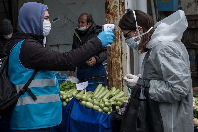 ISTANBUL, TURKEY - APRIL 04: Besiktas municipality police and employees distribute masks, check ID's and take the temperature of people arriving at the entrance of the Besiktas market on April 04, 2020 in Istanbul, Turkey. Overnight, Turkish President Recep Tayyip Erdogan announced additional measure to halt the spread of coronavirus including issuing a stay-at-home order for all persons under 20 years of age, shutting the road borders of 31 cities and making the wearing of face masks mandatory in public places. Figures from April 3rd, confirm Turkey has 425 deaths and 20,921 positive cases of Coronavirus.  (Photo by Chris McGrath/Getty Images)